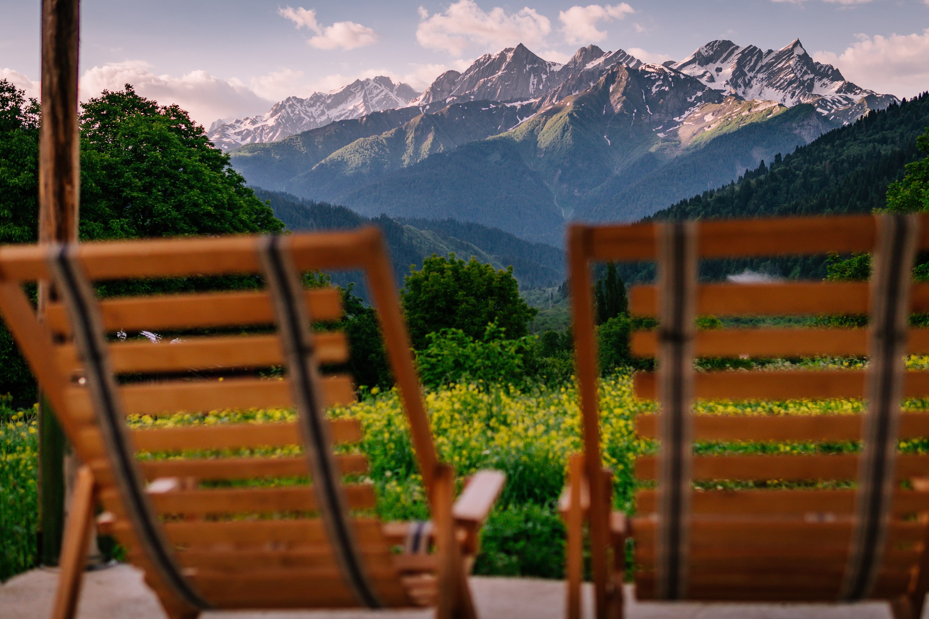 Mountain valley view from Chiora Inn with wooden deck chairs