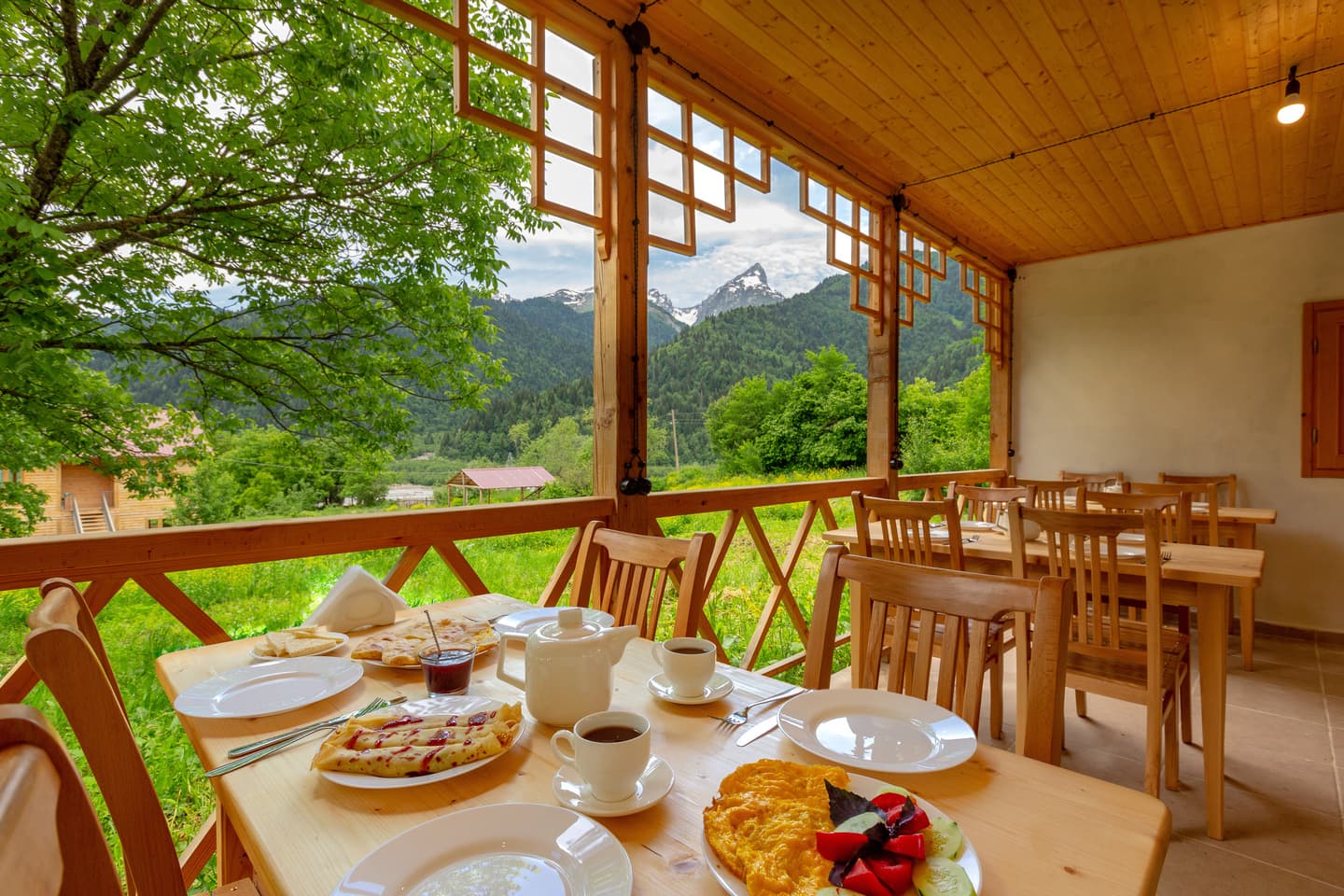 Mountain terrace dining with fresh pastries and mountain views